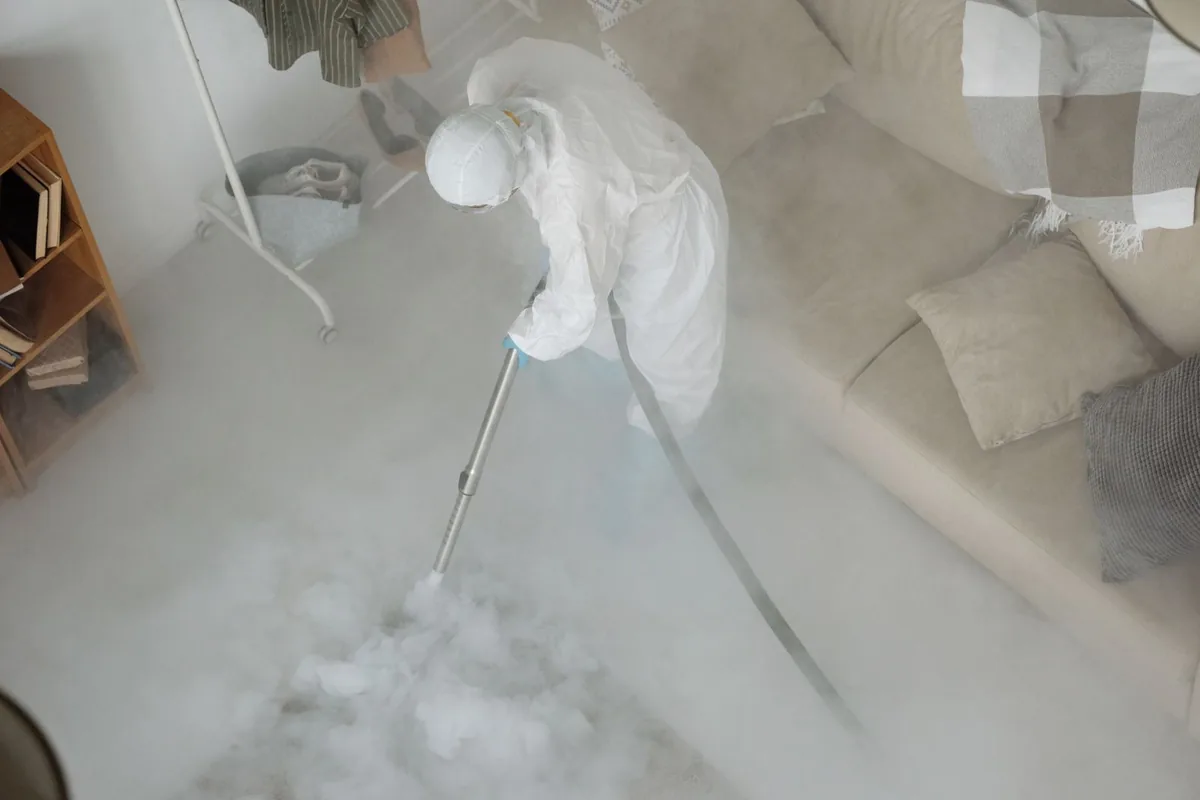 Biohazard cleanup technician in protective equipment, Fort Polk South, LA